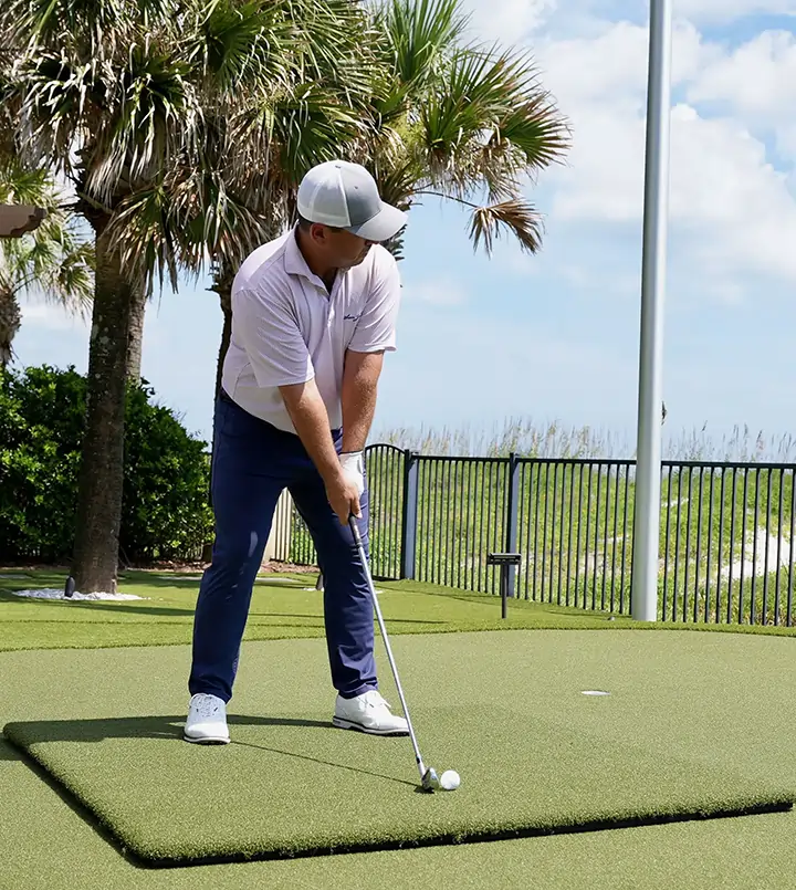 Golfer using SYNLawn golf mat