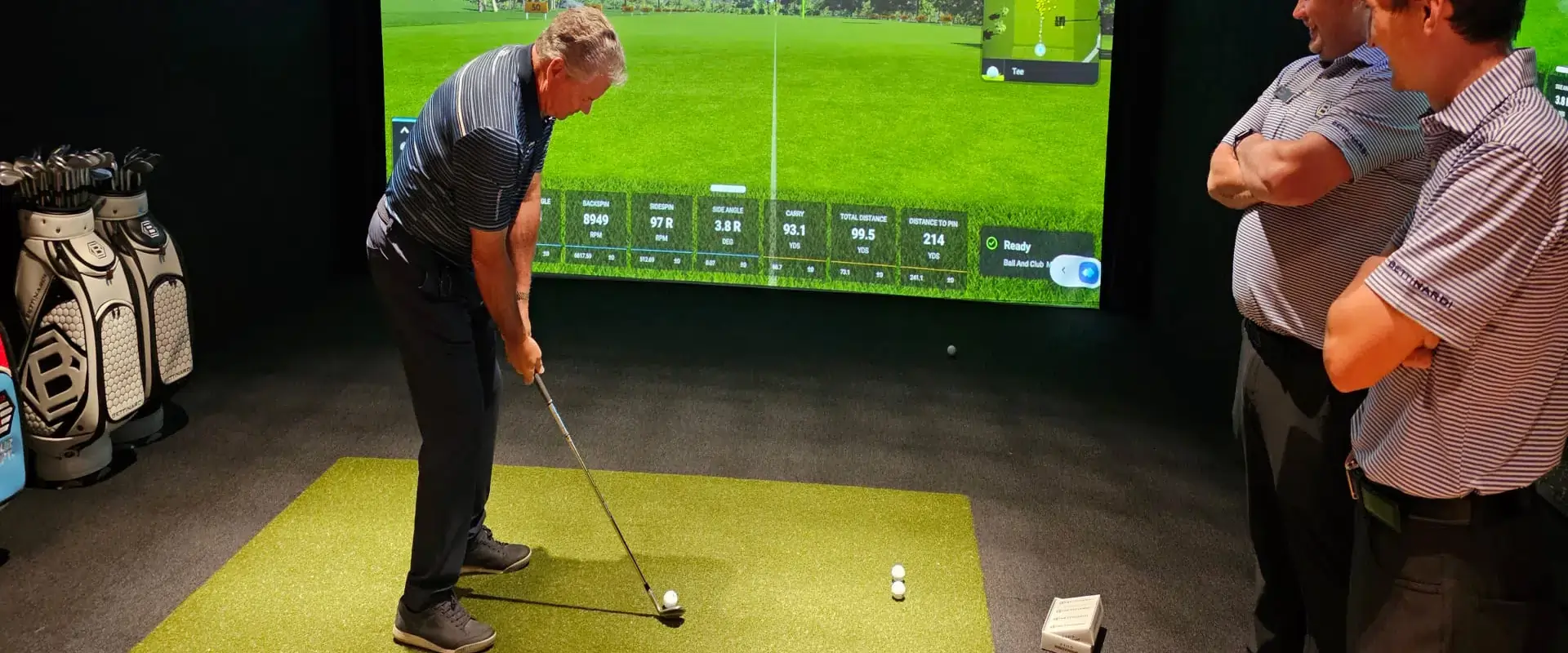 Golf simulator with artificial grass tee box