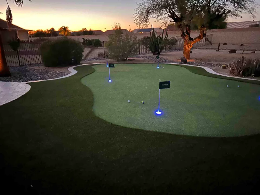 residential backyard putting green at night